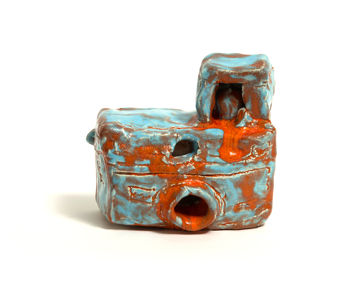 This photo shows a ceramic cameria with an orange and blue glaze